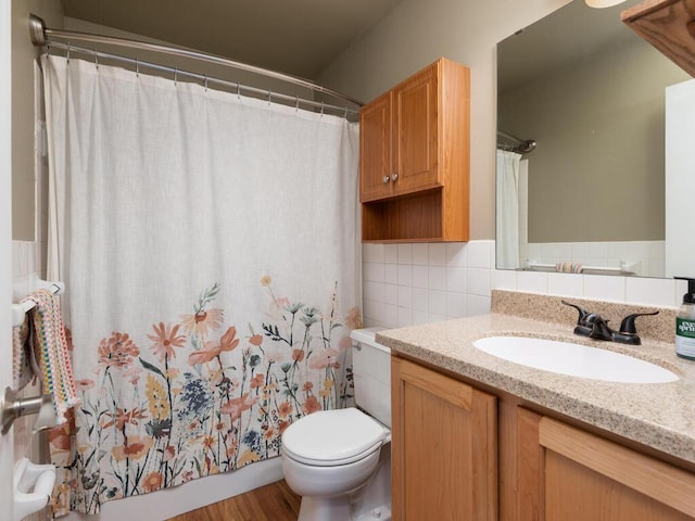 full bath with tile walls, backsplash, vanity, and toilet