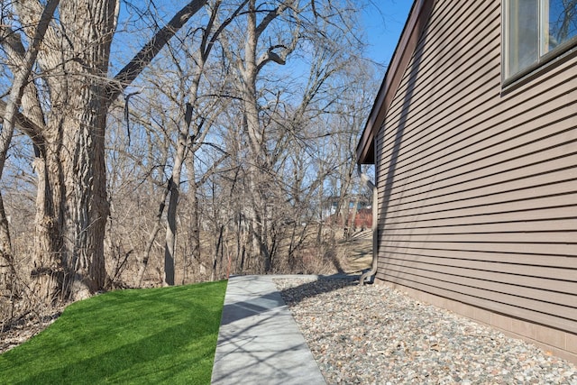 view of property exterior featuring a lawn