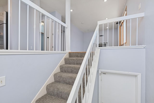 stairs featuring baseboards and recessed lighting