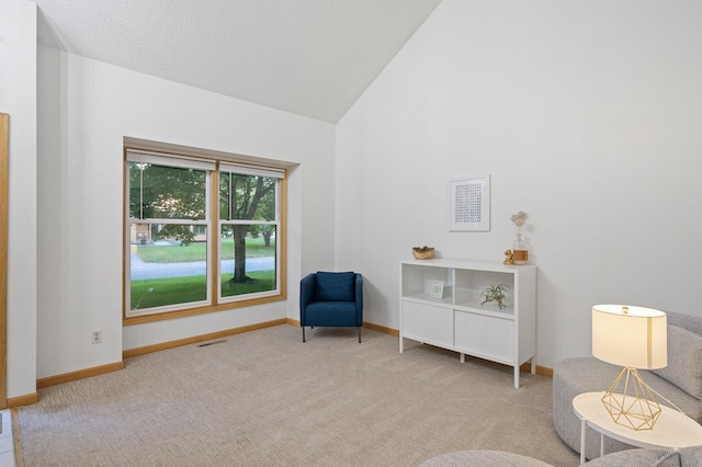 sitting room featuring high vaulted ceiling, carpet, visible vents, and baseboards