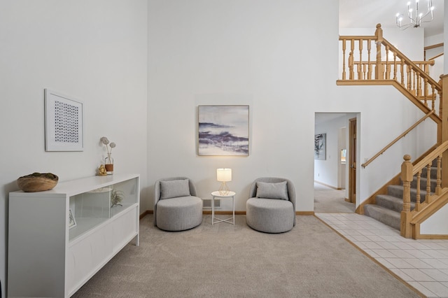 sitting room with stairs, carpet floors, and a high ceiling