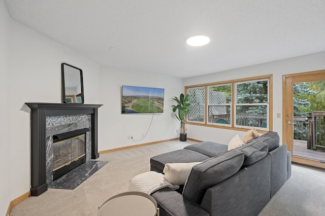 carpeted living room with a fireplace, baseboards, and a textured ceiling