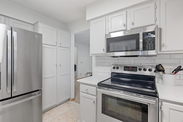 kitchen featuring stainless steel appliances, tasteful backsplash, light countertops, and white cabinets