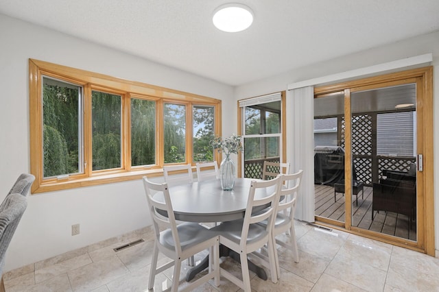 dining room featuring light tile patterned floors and visible vents