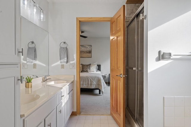 ensuite bathroom featuring a sink, a shower stall, ensuite bath, and double vanity