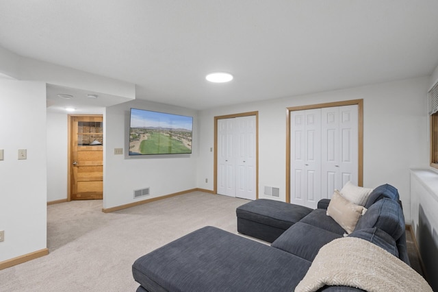 living area with light colored carpet, visible vents, and baseboards