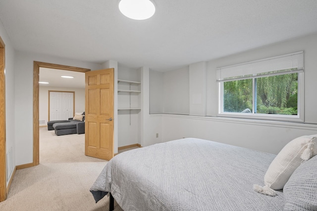 bedroom with carpet floors and baseboards