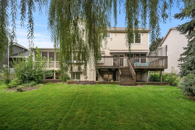 rear view of house featuring a sunroom, a lawn, a deck, and stairs