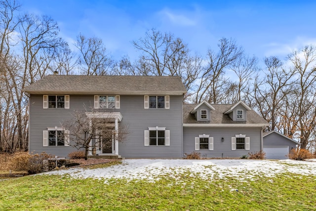 colonial-style house with an outbuilding and a shingled roof