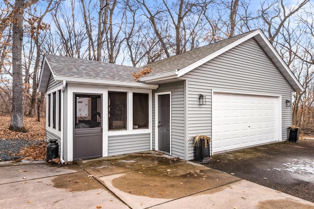 view of front of house featuring a shingled roof and a sunroom