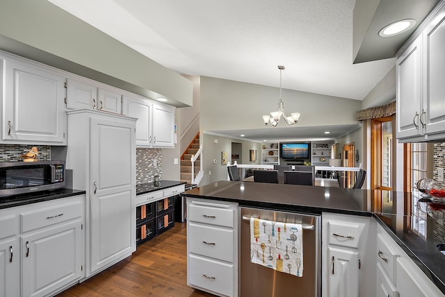 3220 Highlands Rd, Brooklyn Park, MN 55443 - kitchen with lofted ceiling, dark countertops, decorative backsplash, white cabinetry, and open floor plan