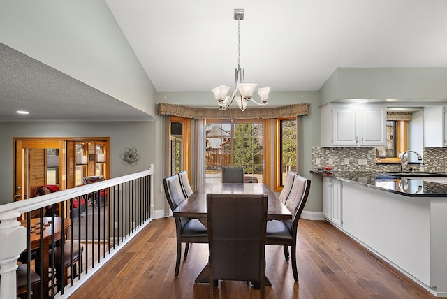 3220 Highlands Rd, Brooklyn Park, MN 55443 - dining area featuring lofted ceiling, hardwood / wood-style flooring, and a chandelier