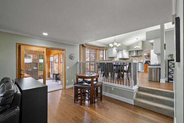 3220 Highlands Rd, Brooklyn Park, MN 55443 - dining space with a chandelier, healthy amount of natural light, a textured ceiling, wood-type flooring, and ornamental molding