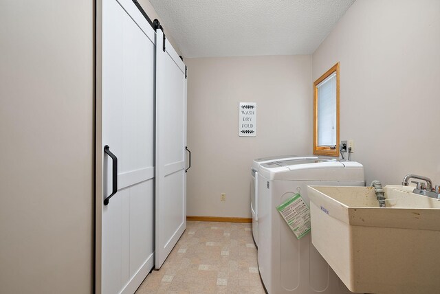 3220 Highlands Rd, Brooklyn Park, MN 55443 - washroom with washing machine and dryer and a textured ceiling