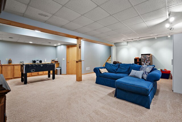 3220 Highlands Rd, Brooklyn Park, MN 55443 - living area featuring light colored carpet, rail lighting, stairway, and a drop ceiling