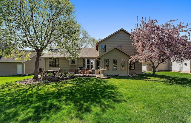 3220 Highlands Rd, Brooklyn Park, MN 55443 - back of property with a lawn, a patio, and roof with shingles