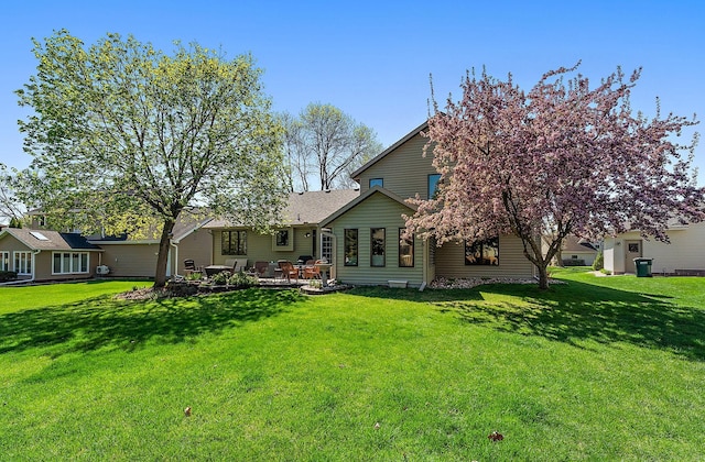 3220 Highlands Rd, Brooklyn Park, MN 55443 - rear view of house with a yard and a patio area