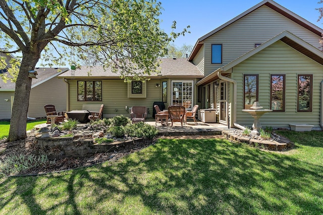 3220 Highlands Rd, Brooklyn Park, MN 55443 - back of house with a patio, a yard, and a shingled roof