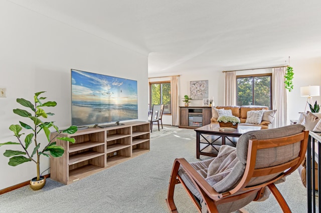 living area with carpet floors, plenty of natural light, and baseboards