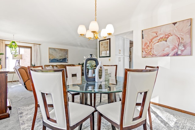 dining room with carpet floors, an inviting chandelier, and baseboards