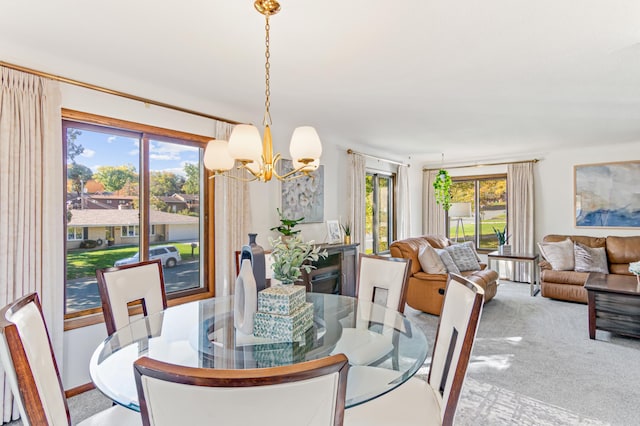 carpeted dining area featuring an inviting chandelier