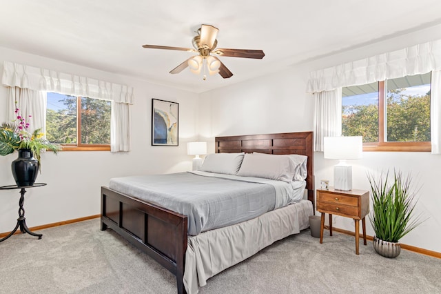 carpeted bedroom featuring ceiling fan and baseboards