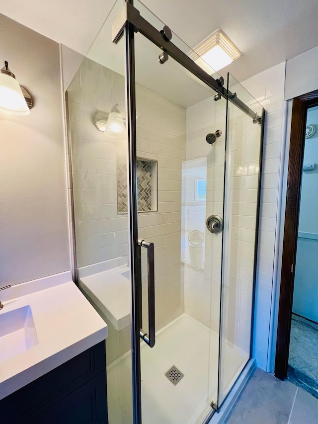 bathroom with a stall shower and vanity