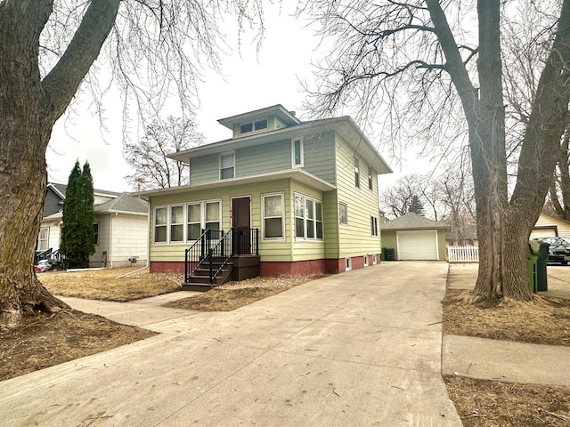 american foursquare style home with a garage, an outdoor structure, and concrete driveway