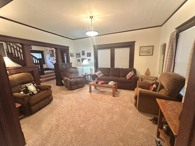 living area with stairway, carpet, and ornamental molding