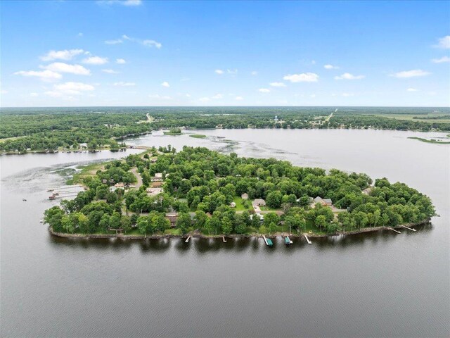 birds eye view of property with a water view and a wooded view