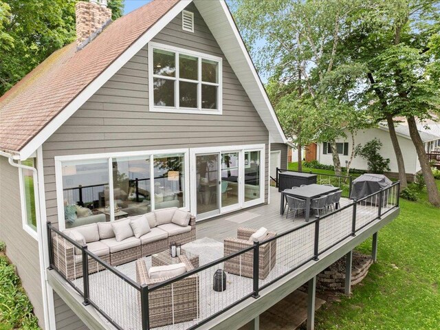back of house with a deck, a lawn, a chimney, and an outdoor hangout area