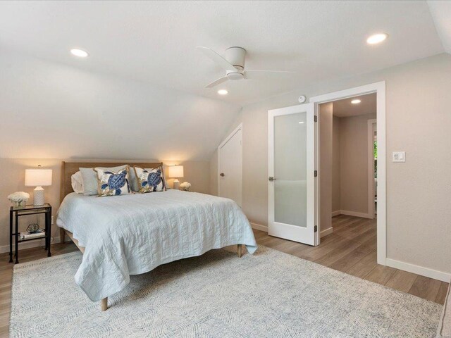 bedroom featuring vaulted ceiling, ceiling fan, baseboards, and wood finished floors