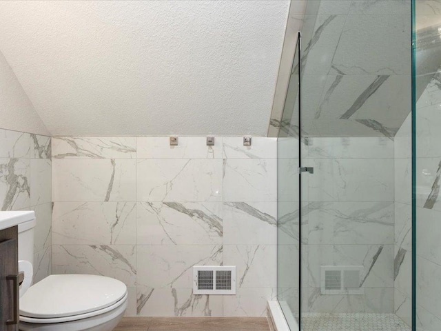 full bathroom with a marble finish shower, toilet, visible vents, and vanity
