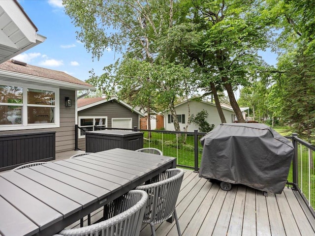 wooden terrace featuring outdoor dining space and area for grilling