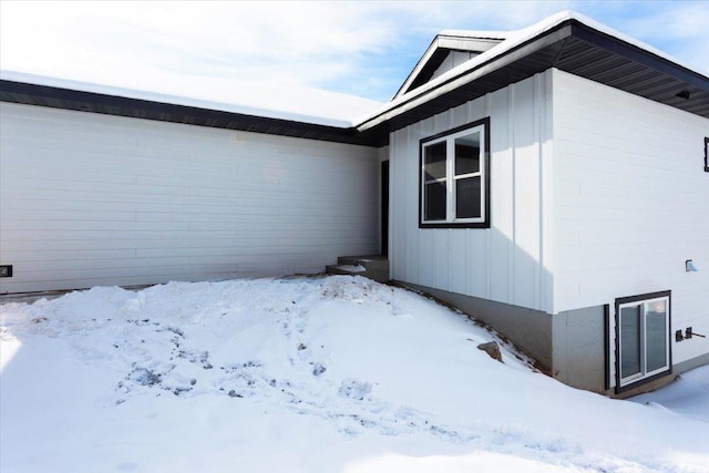 view of snowy exterior featuring board and batten siding