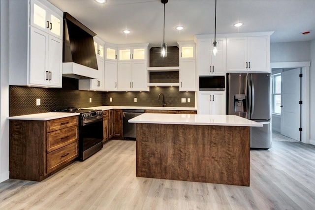 kitchen featuring electric range oven, stainless steel fridge with ice dispenser, wall chimney range hood, built in microwave, and dishwasher