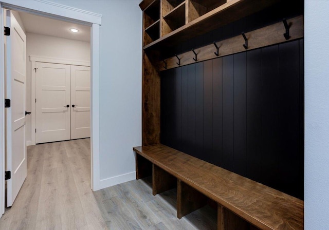 mudroom with baseboards and light wood-type flooring