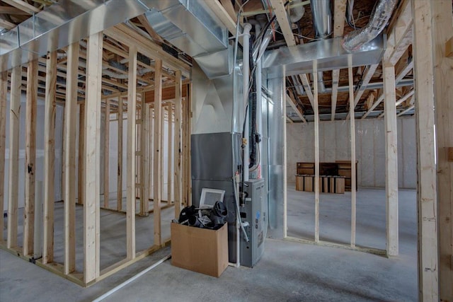 unfinished basement featuring heating unit