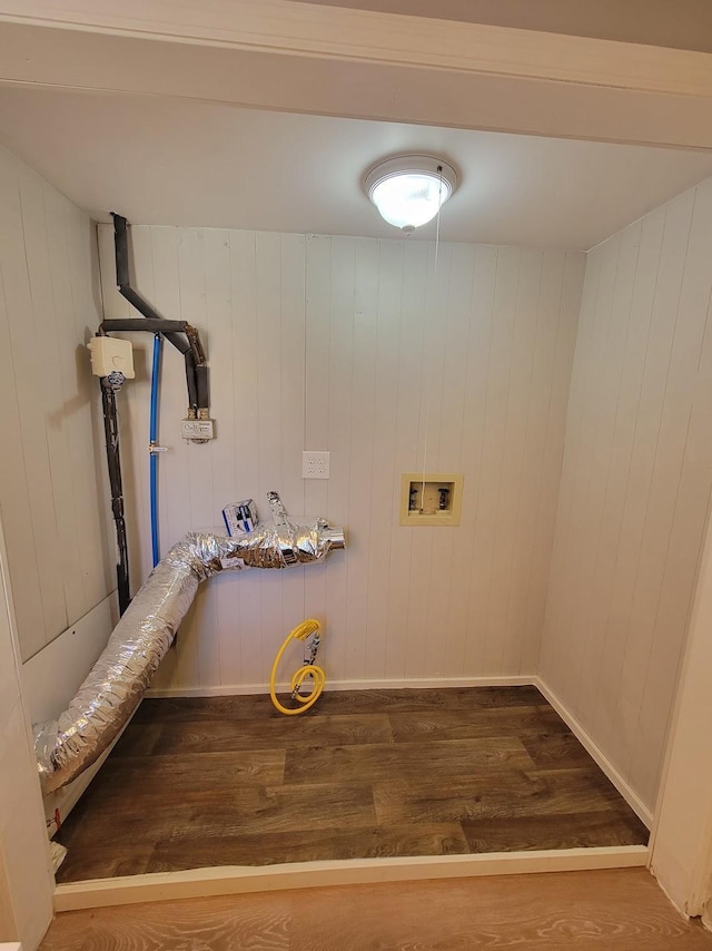 washroom featuring laundry area, hookup for a washing machine, baseboards, and wood finished floors