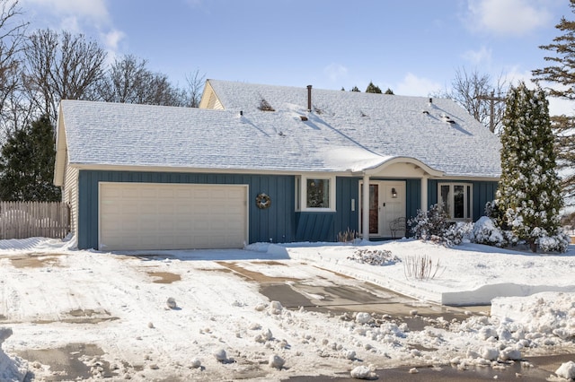 single story home with board and batten siding, fence, a garage, and roof with shingles