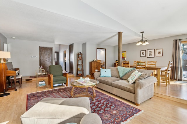 living room featuring light wood finished floors and a chandelier