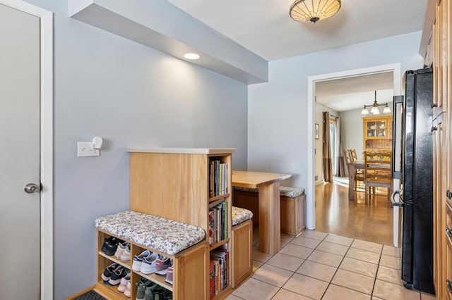 hall with light tile patterned floors