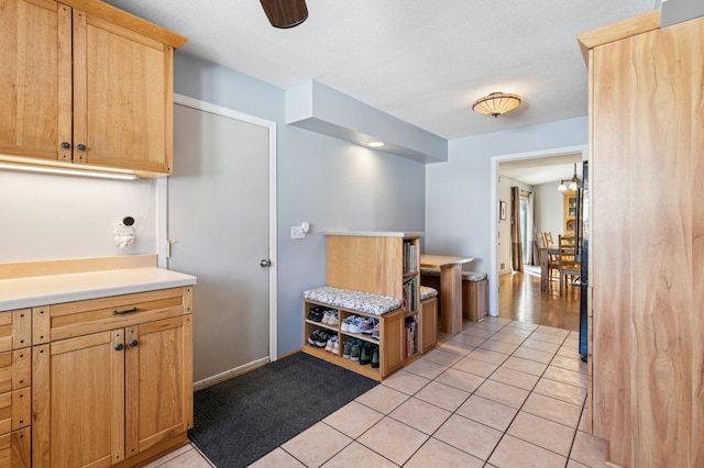 kitchen with light tile patterned flooring, light brown cabinets, and light countertops