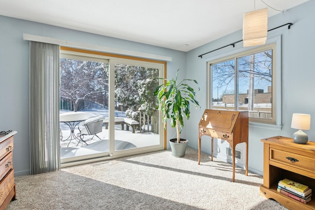 doorway to outside featuring carpet flooring and baseboards