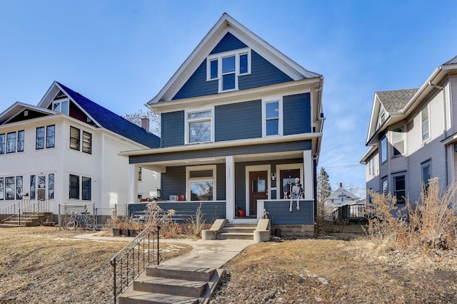 american foursquare style home with a porch