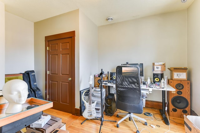 office area featuring wood-type flooring and baseboards