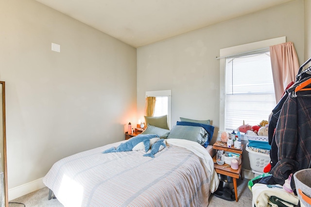 bedroom featuring carpet floors and baseboards