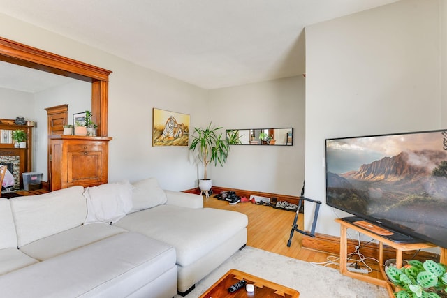 living area featuring baseboards and wood finished floors