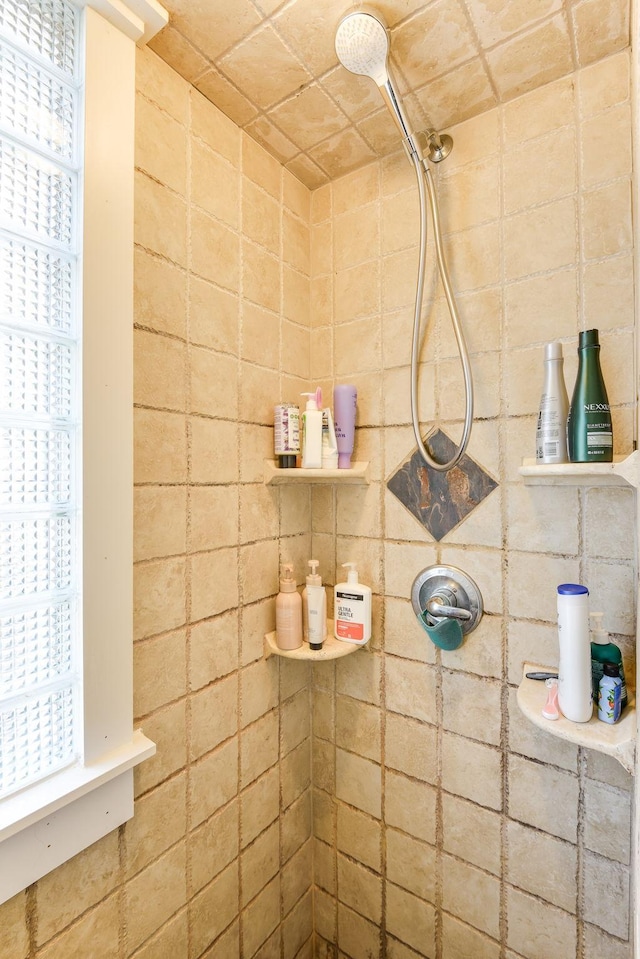 bathroom with tiled shower