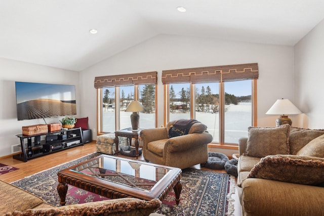 living area featuring lofted ceiling, recessed lighting, and wood finished floors